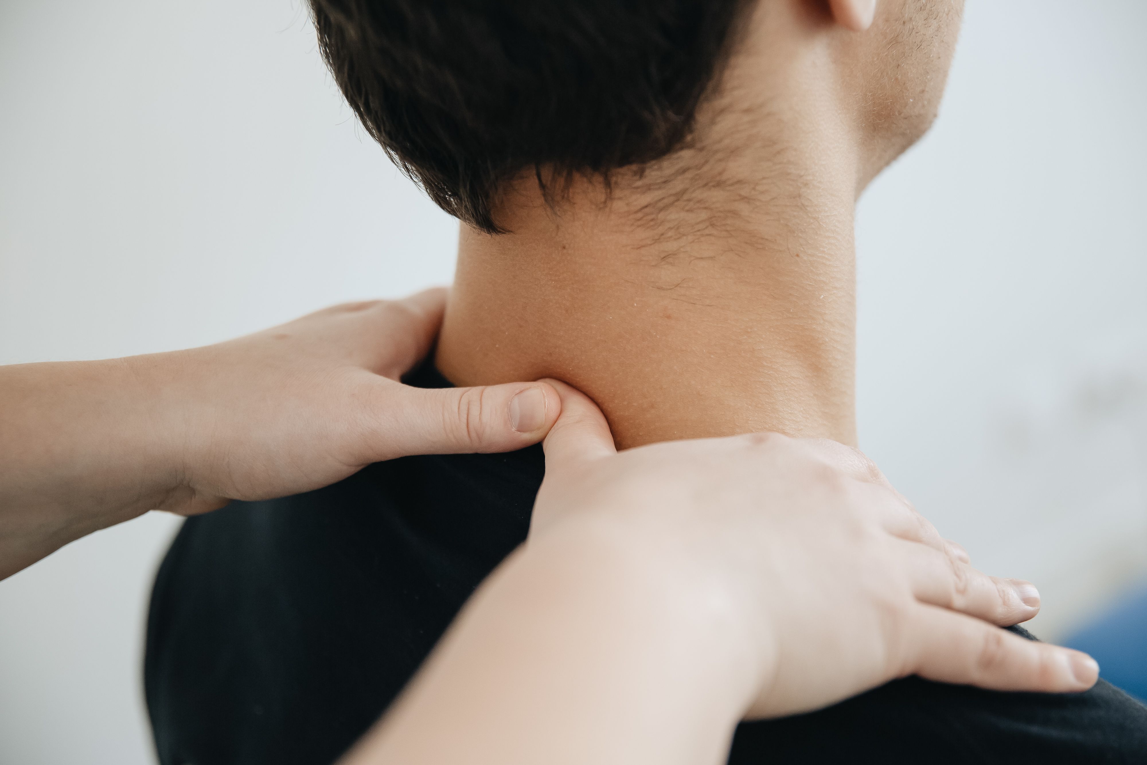 Hands treating neck for pinched nerve relief