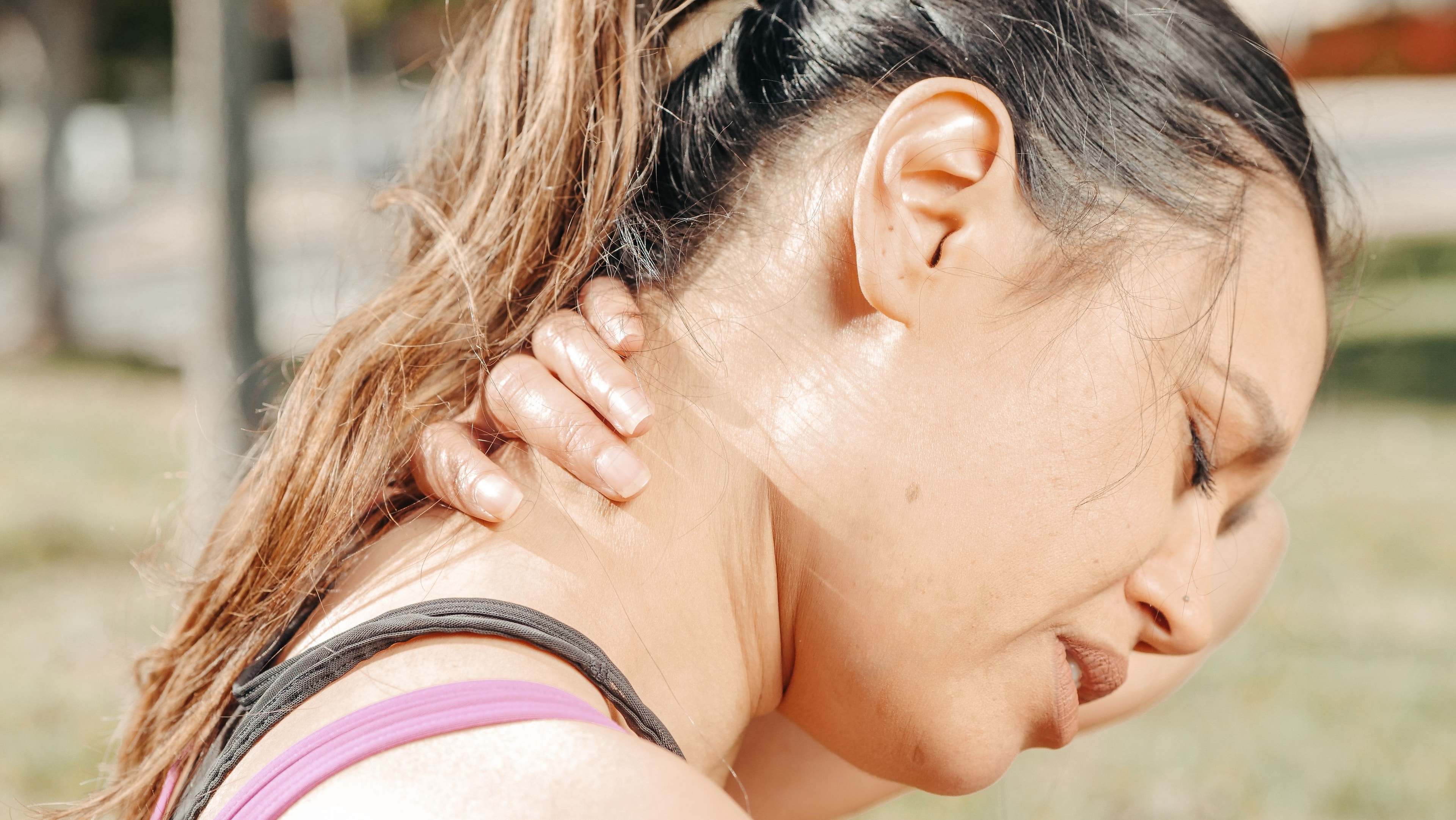 Woman holding neck in pain from whiplash